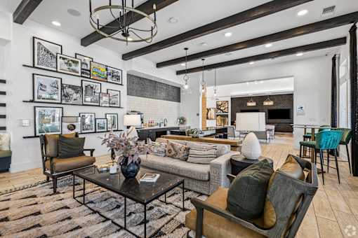 A living room with a black and white color scheme and a variety of furniture.