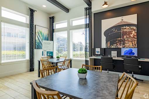 A conference room with a large table and chairs.