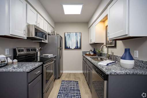 A kitchen with a refrigerator, oven, and microwave.at Addison at Sutherland, Knoxville, 37909  