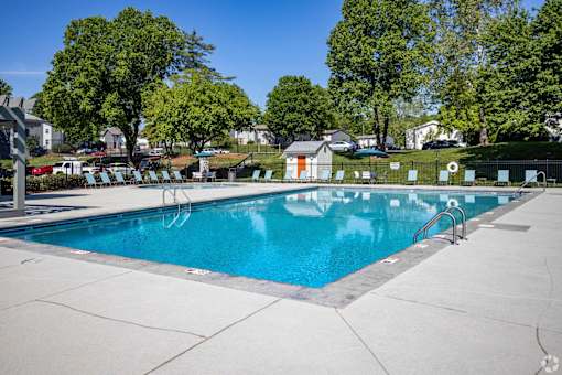 A large swimming pool surrounded by trees and a fence.at Addison at Sutherland, Tennessee  