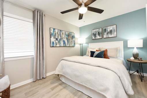 A bedroom with a large bed and a ceiling fan.at Addison at Sutherland, Tennessee  