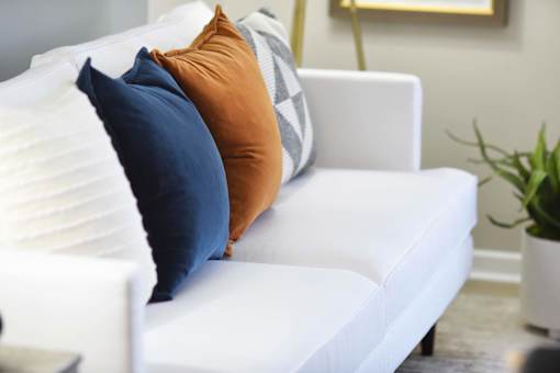 A white couch with three pillows on it.at Addison at Sutherland, Knoxville, TN 37909  