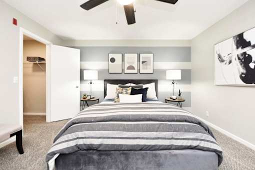 A bedroom with a large bed and a ceiling fan.at Addison at Sutherland, Knoxville, TN  