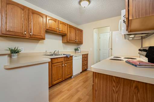 A kitchen with wooden cabinets and white appliances.