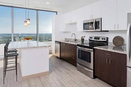 a kitchen with a island and stainless steel appliances