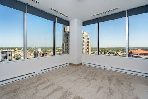 an empty living room with a view of the city