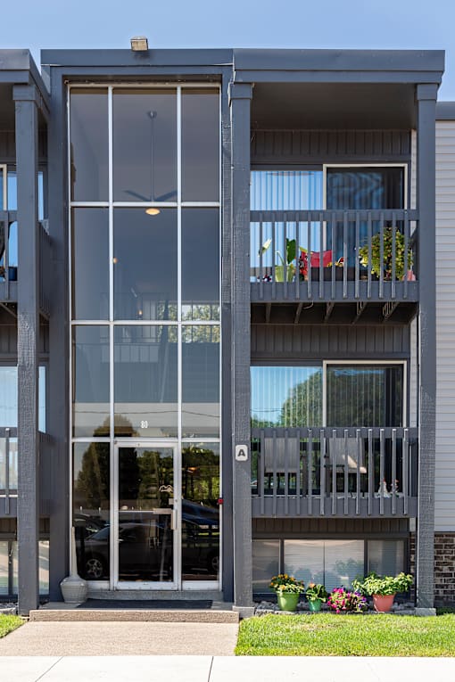 A modern house with a balcony and glass doors.