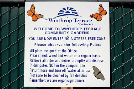 A sign welcoming people to Winthrop Terrace Community Gardens and outlining the rules.