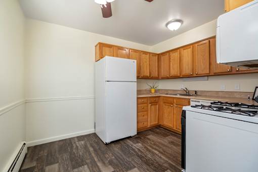 A kitchen with a white refrigerator and a white stove.