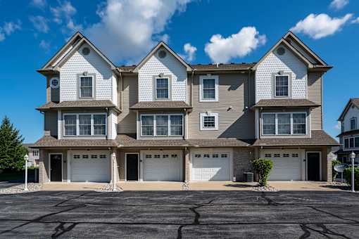 A large, two-story house with a garage on the ground floor.