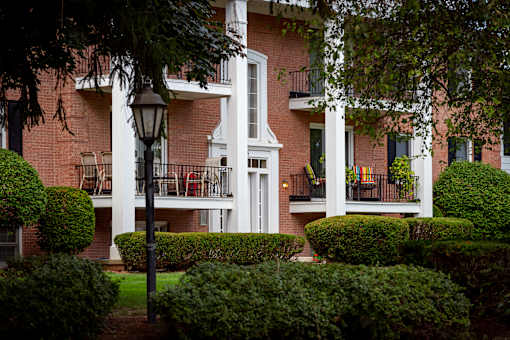 A white building with a black lamp post in front of it.