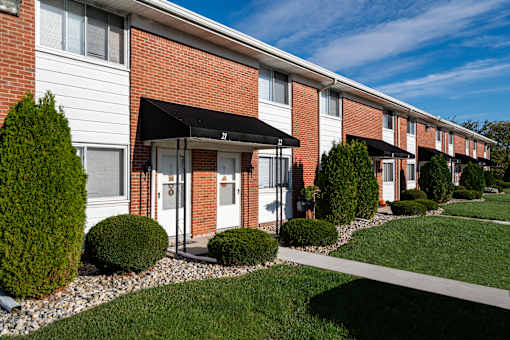 A row of houses with a white and red brick facade.