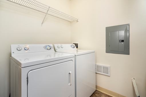 A white washing machine and dryer in a small laundry room.
