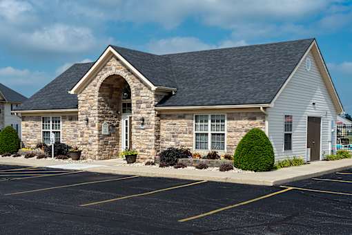 A church with a parking lot in front.