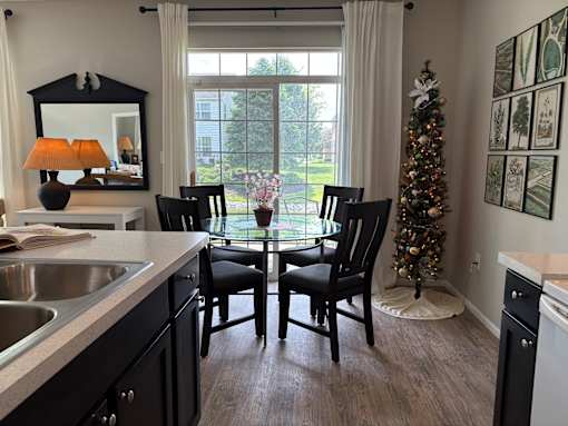 A kitchen with a table and chairs and a Christmas tree.