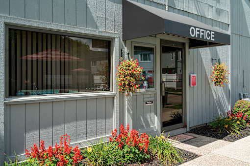 A grey building with a sign that says "OFFICE" on the front.