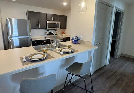 A kitchen with a table set for two.