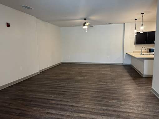 A room with a wooden floor and a ceiling fan.
