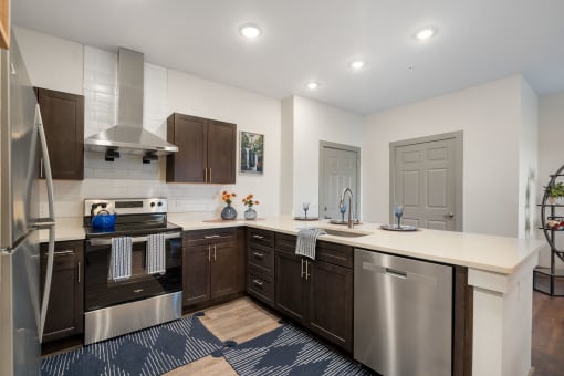 a kitchen with stainless steel appliances and a white counter top at 41 North Apartments, Fort Wayne Indiana