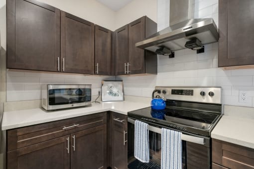 a kitchen with a stove top oven and a microwave at 41 North Apartments, Fort Wayne, IN 46835