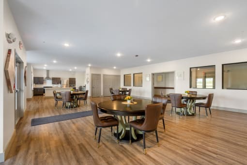 a large living room with a dining area and a kitchen with a table and chairs at 41 North Apartments, Indiana, 46835