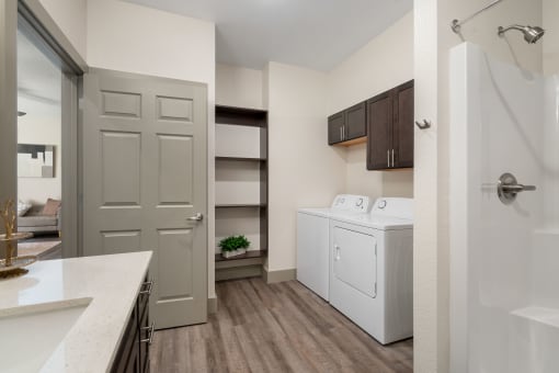 a spacious kitchen with a washer and dryer and a door to a closet at 41 North Apartments, Indiana