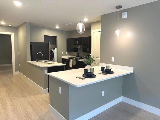 an open kitchen with a large island in the middle at MountainView Flats, Glenwood Springs