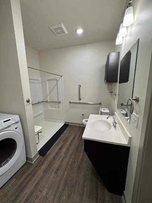 A small bathroom with a washer and dryer.