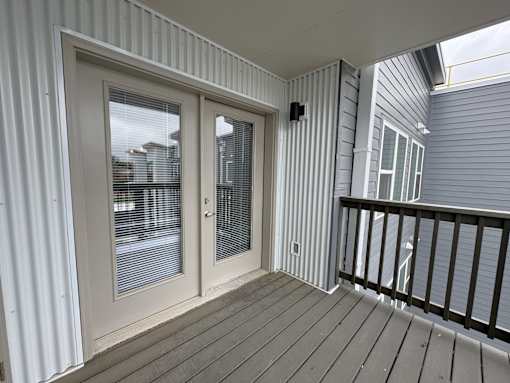 A balcony with a sliding door and a railing.