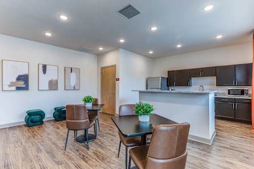 A modern kitchen with a dining table and chairs.