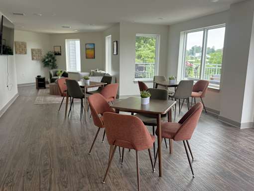 A dining room with a long table and chairs.