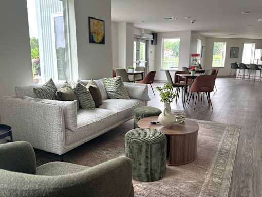 A living room with a couch, chairs, and a coffee table.