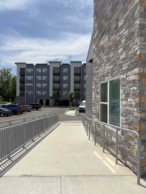A parking lot with a building in the background.