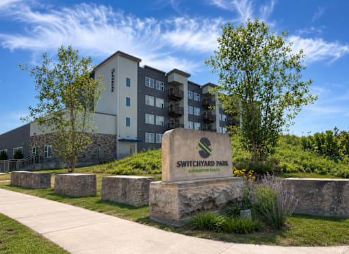 A building with a sign that says Switchyard Park in front of it.