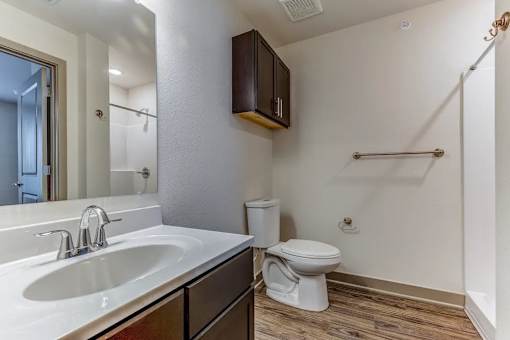 A bathroom with a white sink and toilet.