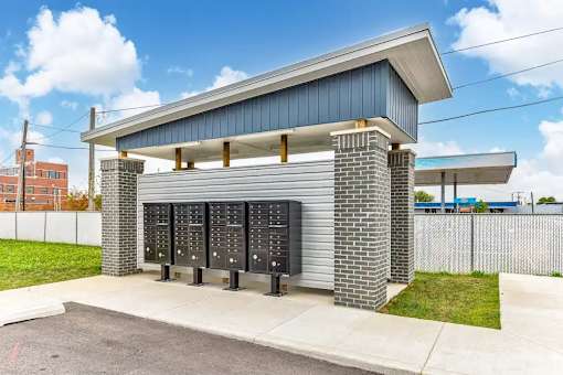 A parking garage with a blue roof and brick pillars.