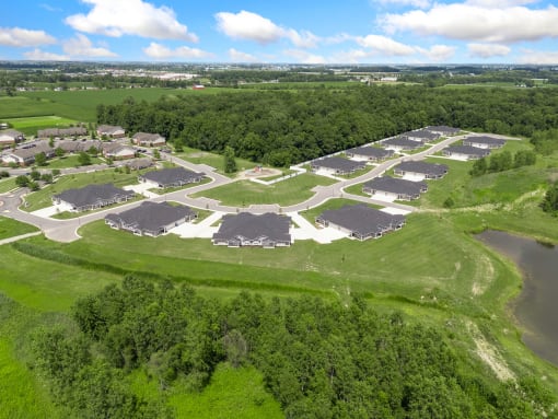 an aerial view of a community with houses and a body of water at Morada at Maysville, Fort Wayne Indiana