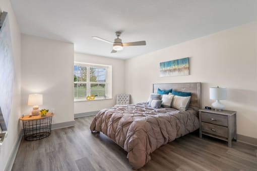 a bedroom with a bed and a ceiling fan at Morada at Maysville, Fort Wayne, IN