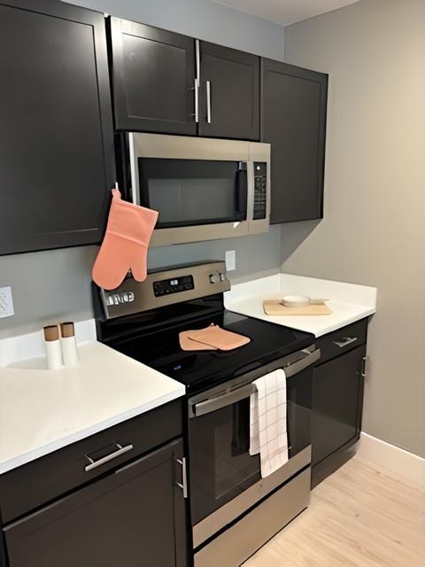 a kitchen with a stove and a microwave at MountainView Flats, Glenwood Springs