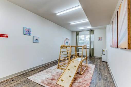 A room with a wooden slide in the middle of the room.