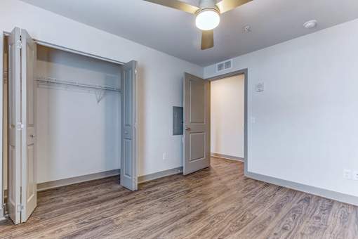 A room with a sliding door and a ceiling fan.