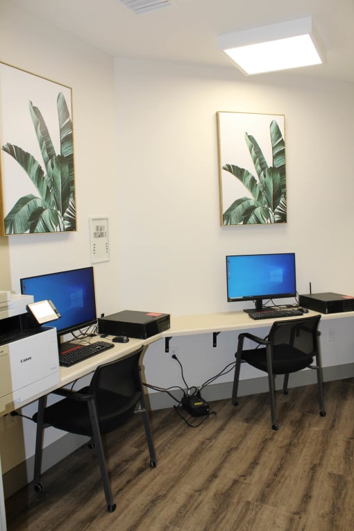 two computer desks in a room with two computers on them  at Haven Homes Apartments, LP, Plainfield, IN