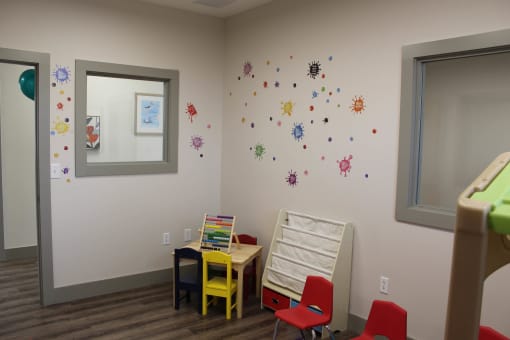 a childs play room with a table and chairs  at Haven Homes Apartments, LP, Plainfield, IN, 46168
