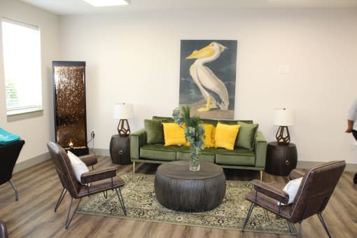 a living room with a green couch and a painting on the wall  at Haven Homes Apartments, LP, Plainfield, IN