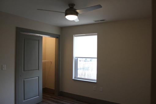 an empty room with a window and a ceiling fan  at Haven Homes Apartments, LP, Indiana, 46168