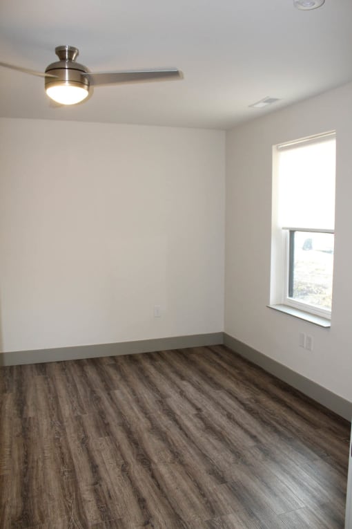 an empty room with a ceiling fan and a window  at Haven Homes Apartments, LP, Plainfield, 46168