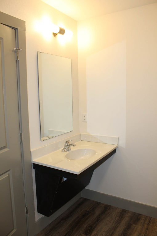 a small bathroom with a sink and a mirror  at Haven Homes Apartments, LP, Plainfield, Indiana