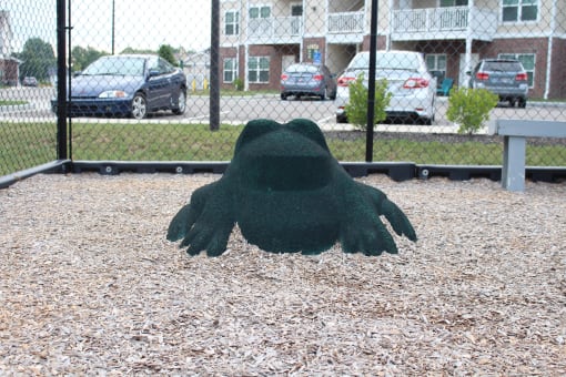 a statue of a hand in front of a fence at Salem Place Apartments, Daleville, Indiana