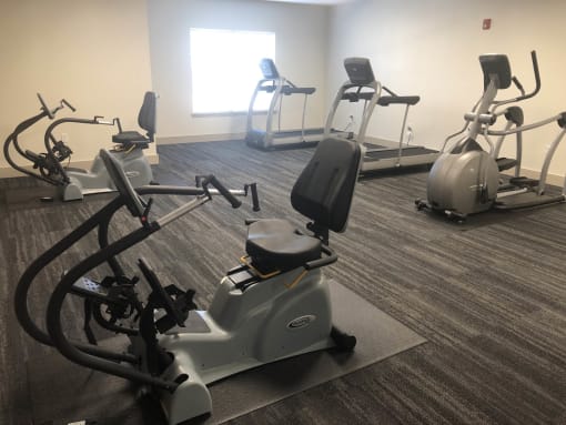 a gym with several exercise bikes in it  at Lake Park Market Apartments, Hobart, IN