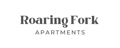 a row of apartments with cars parked in a parking lot  at Roaring Fork Apartments, Basalt, 81621